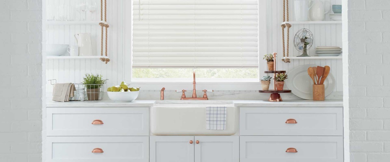 White kitchen with copper hardware 